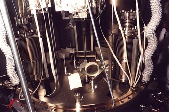 A look into modecleaner tank TCMa. The top plate with suspension unit and local controls has been lifted. One sees the three stacks and two modecleaner mirrors. A look into modecleaner tank TCMa. The top plate with suspension unit and local controls has been lifted. One sees the three stacks and two modecleaner mirrors.