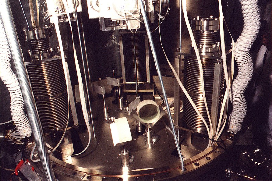 A look into modecleaner tank TCMa. The top plate with suspension unit and local controls has been lifted. One sees the three stacks and two modecleaner mirrors.