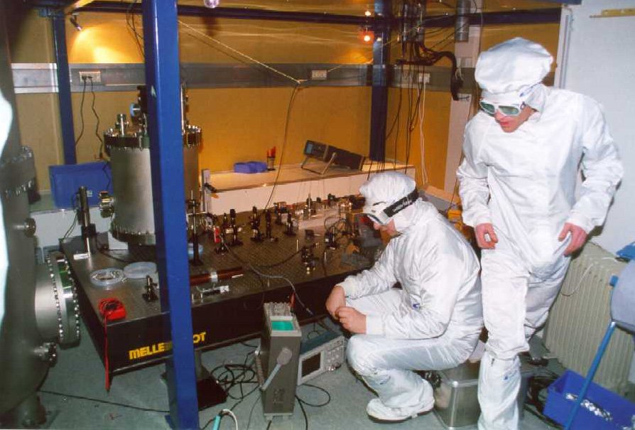 Ken and David control the modulation index of the Pockels cell. The vacuum chamber contains the reference cavity of the frequency stabilization.
