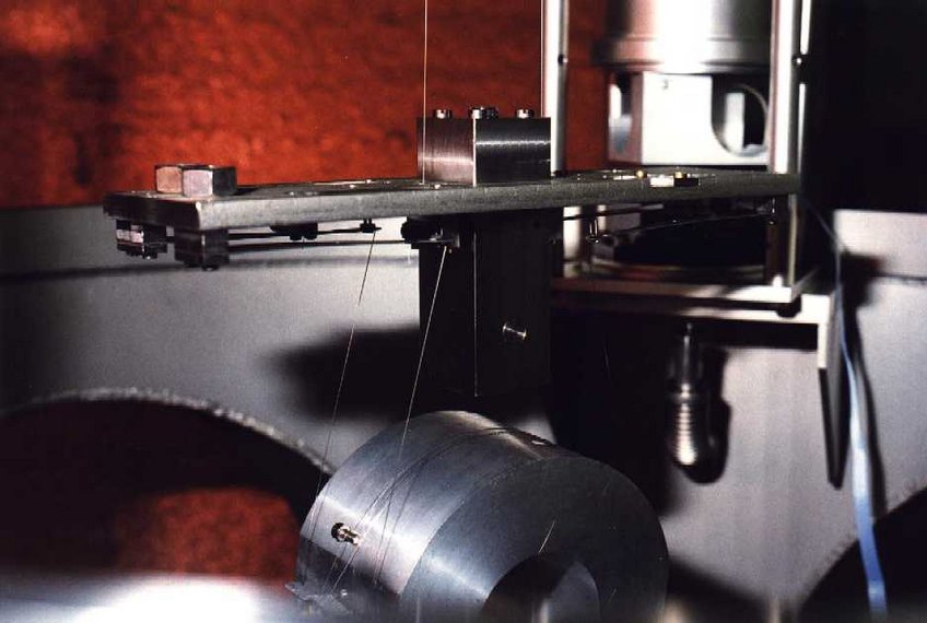 Details of the upper mass: suspension wires and four small cantilever springs for the intermediate mass. Details of the upper mass: suspension wires and four small cantilever springs for the intermediate mass.