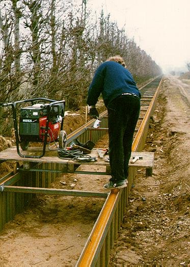 The welders use a small cart running on the I-beams with a portable generator put atop.