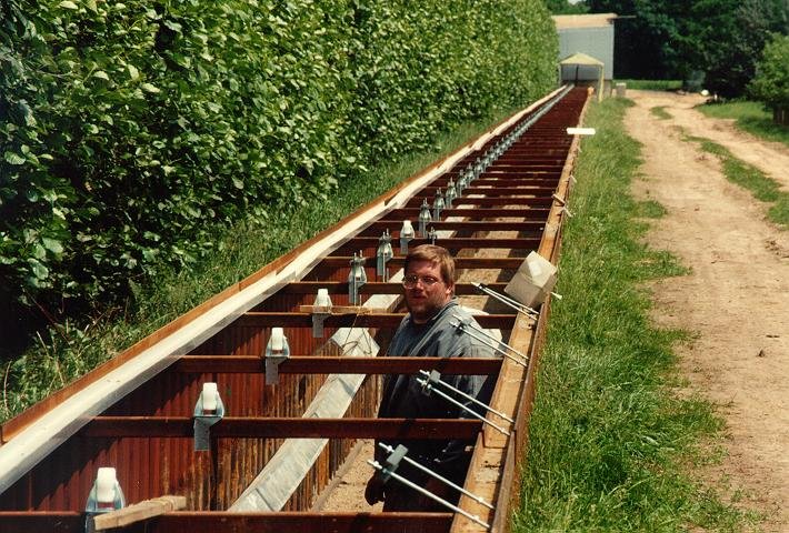 Hans in the trench, installing the rail, which is hung each 3 m from the reinforcement beams between the panels. The wheels sitting atop the reinforcement beams allow thermal expansion of the rail, which is bolted together at the joints and therefore acts as one long rail. The thermal expansion between winter and summer of the whole rail is expected to be roughly 60 cm.