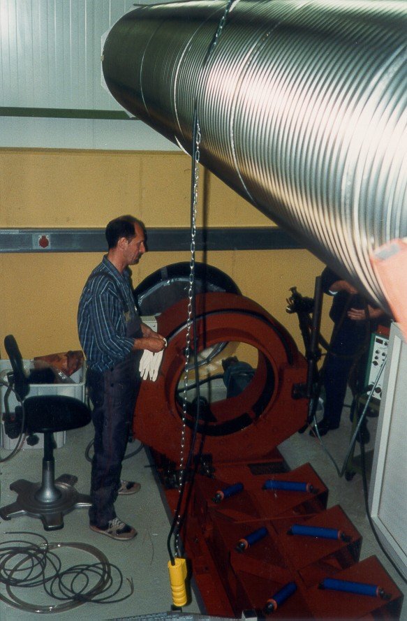 The tube hovers above the welding machine.